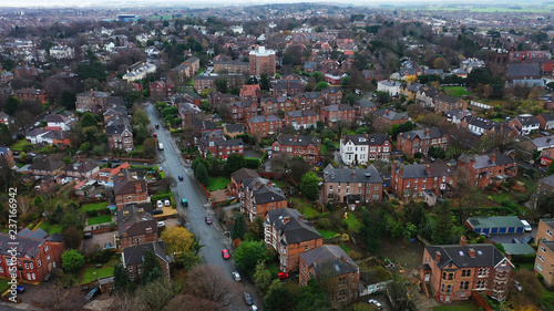Aerial view over suburban homes and roads in Birkenhead, UK