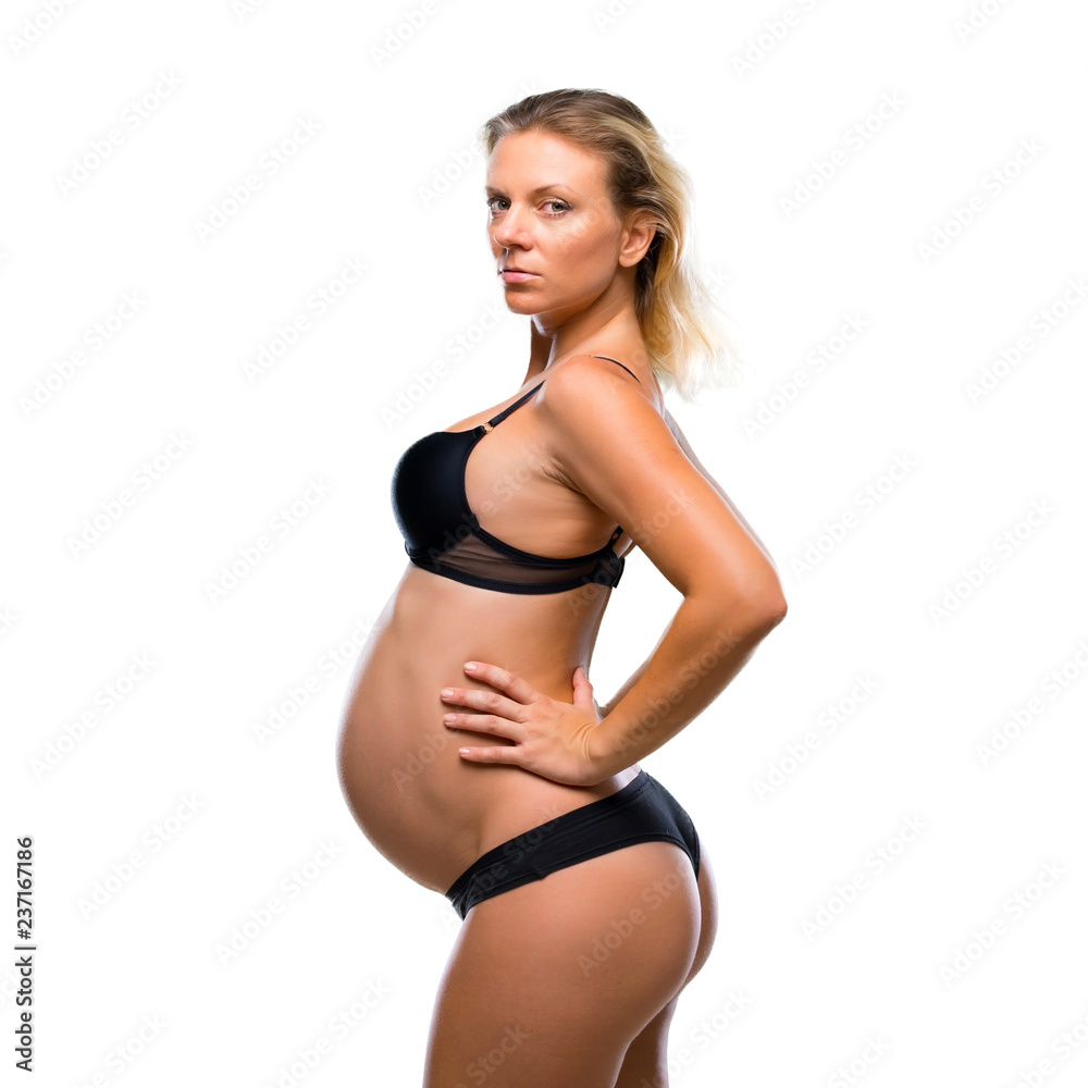 Blonde pregnant woman in underwear on isolated white background Blonde pregnant woman in underwear on isolated white background