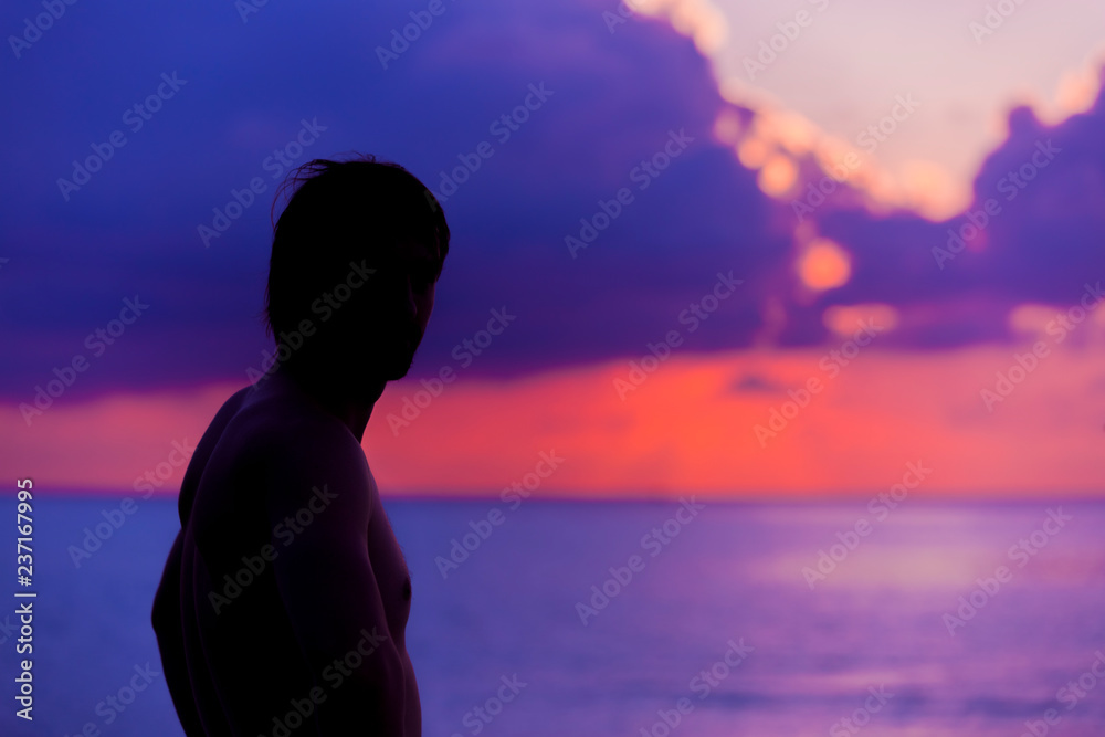 Silhouette of the Man looking at the Sunset.