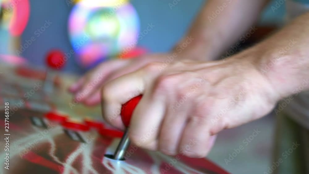 Man playing arcade games in 4k slow motion 60fps Man playing arcade games in 4k slow motion 60fps