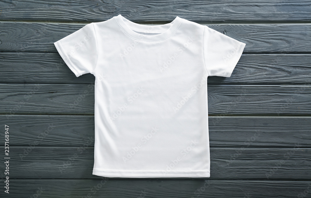 Blank white t-shirt on wooden background - obrazy, fototapety, plakaty 