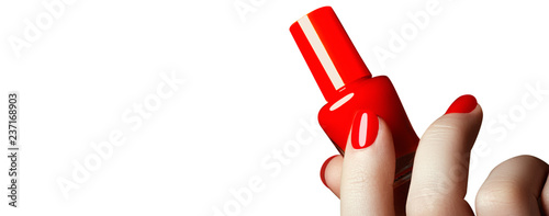 Manicure. Beautiful manicured woman's hands with red nail polish. Bottle of nail polish.Trendy red nails