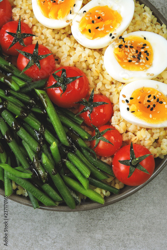 Colorful, healthy foods. flatlay. Buddha bowl with eggs, green beans and cherry tomatoes