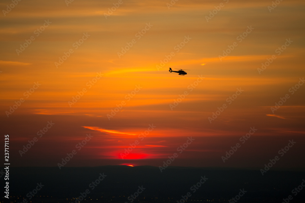 Beautiful image of a helicopter against the sun