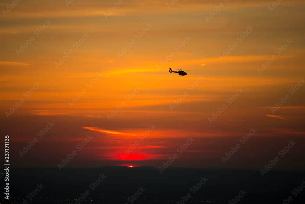 Beautiful image of a helicopter against the sun Beautiful image of a helicopter against the sun