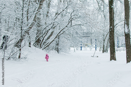 Little girl alone in the snow.