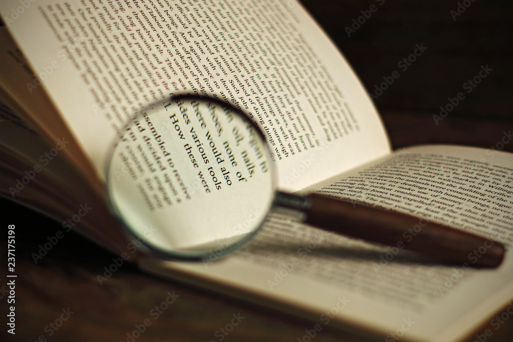 Fototapeta premium Book and magnifying glass