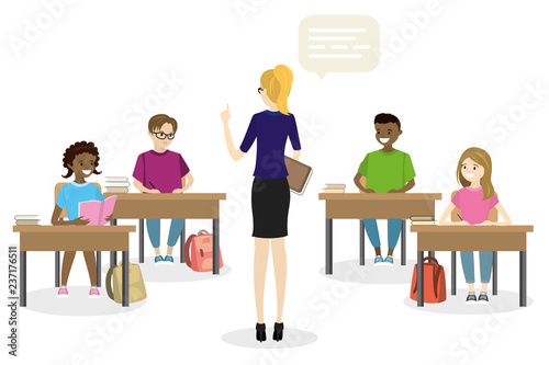 Students teens sitting in the workplace front view, and female teacher standing back view