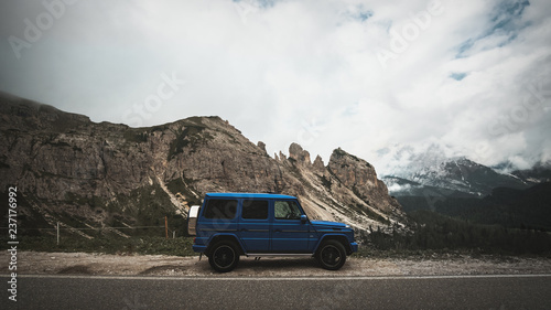 Obraz na płótnie G-Wagon in Italy standing beside the road with mountains