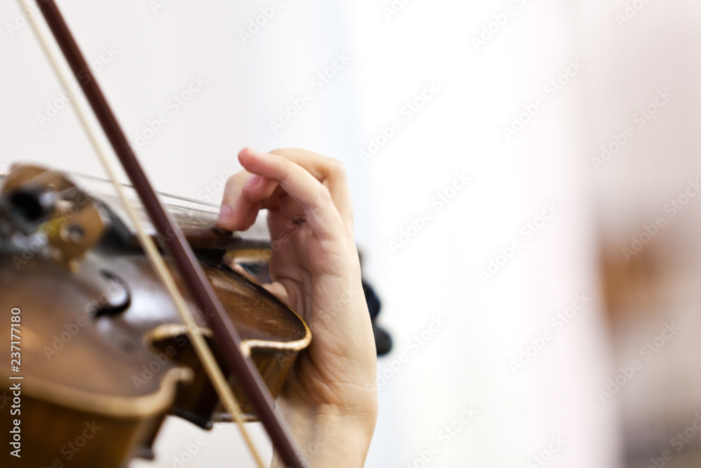 Girl's hand on violin strings closeup Girl's hand on violin strings closeup