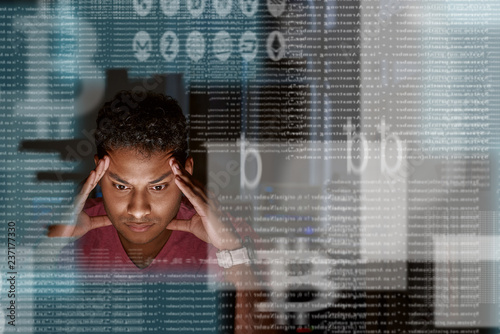 Close-up of young indian programmer thinking how to get more cryptocurrency