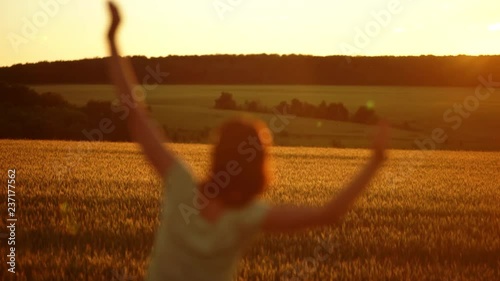 Beautiful silhouette of girl bathing and dancing in rays of the sunset sun. Happy enjoying sunshine concept