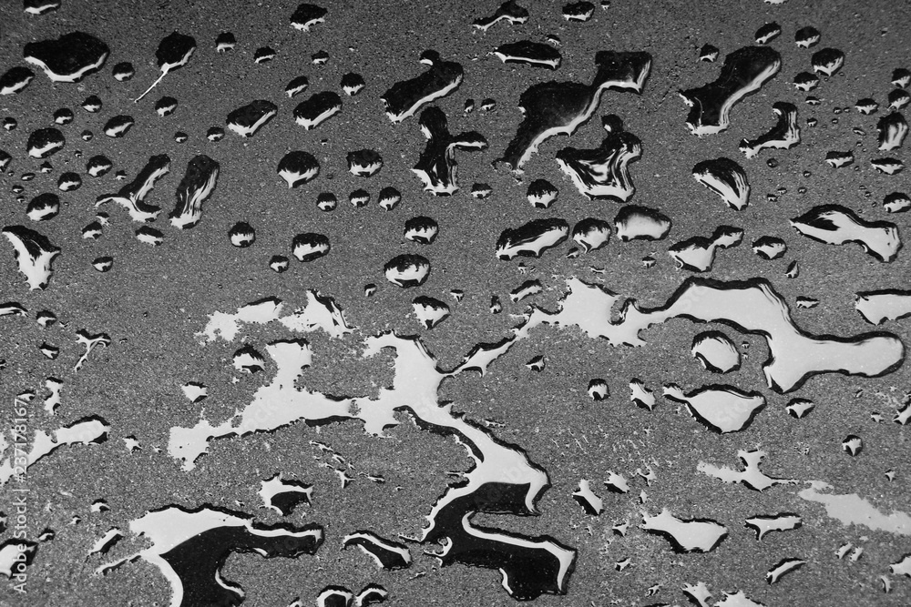 Dark drops of liquid on a hard surface. Fresh asphalt and fuel drops