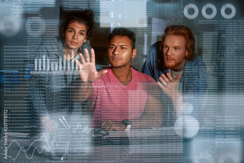 Young team of data analysts are looking over the data photo