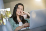 Portrait of stunning brunette smiling at her laptop