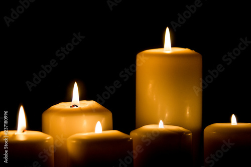 Burning candle in darkness