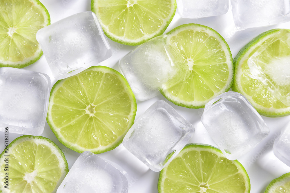 Fresh sliced ripe lime and ice cubes on white background Fresh sliced ripe lime and ice cubes on white background
