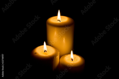 Burning candle in darkness