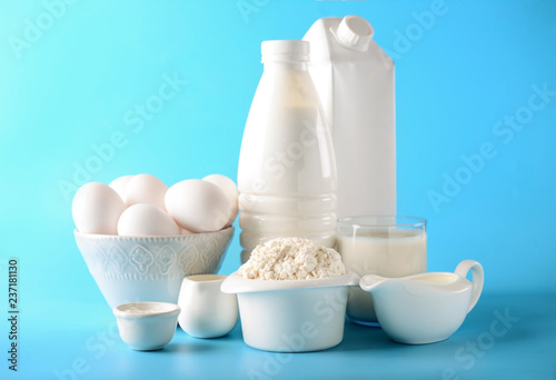 Different milk products with eggs on color background