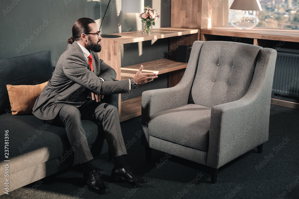 Businessman having hallucinations shaking hand of nobody Businessman having hallucinations shaking hand of nobody
