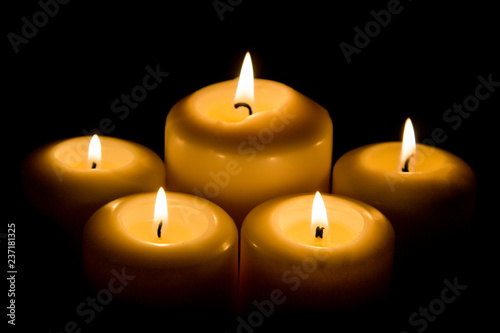 Burning candle in darkness