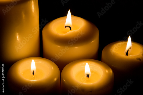Burning candle in darkness
