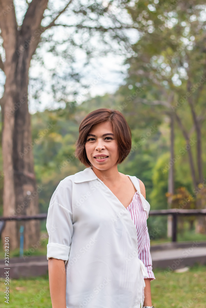 Portrait Asian woman Standing in the grass Background tree Portrait Asian woman Standing in the grass Background tree