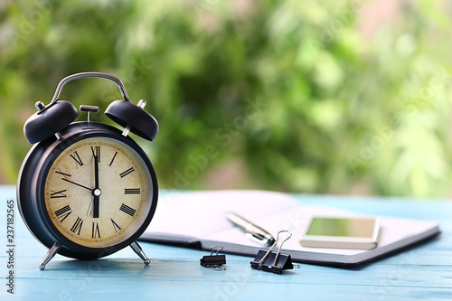 Alarm clock on color wooden...
