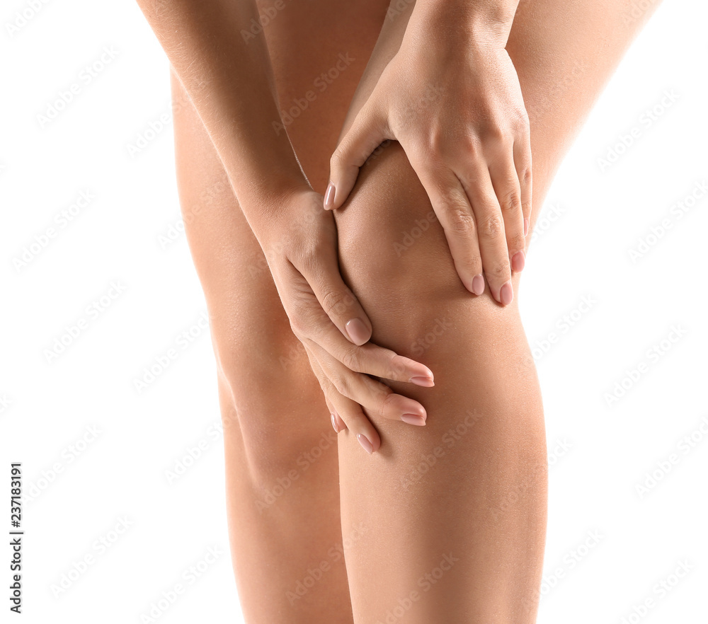 Woman suffering from pain in knee on white background