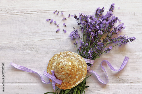 Fototapeta Naklejka Na Ścianę i Meble -  Lavender flowers with straw hat  on wooden background 