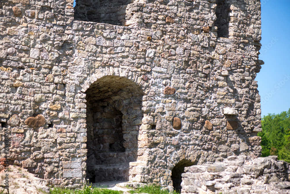 Ancient fortress close to the river or lake. Ruins of medieval castle or palace