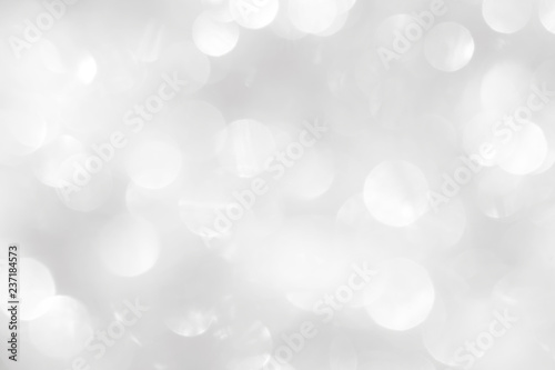 Shiny white background with Christmas patterns of balls and circles, light blur. Texture pattern in gray colors for wrapping a holiday card or wallpaper.