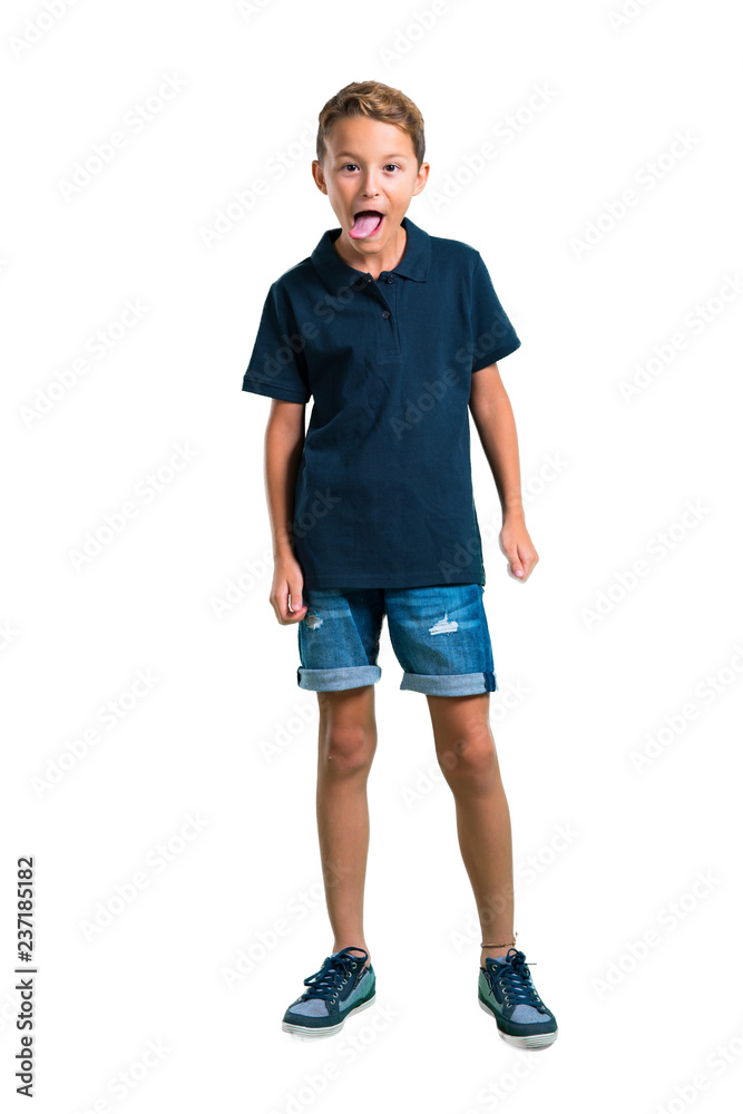 Full body of Little boy showing tongue at the camera having funny look on white background Full body of Little boy showing tongue at the camera having funny look on white background