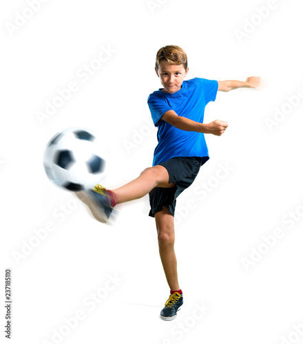 A full-length shot of Boy playing soccer kicking the ball on isolated white background