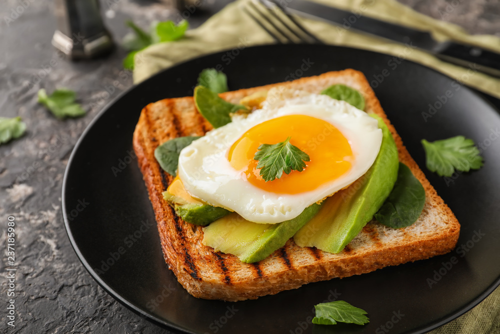 Toasted bread with tasty fried egg on plate Toasted bread with tasty fried egg on plate