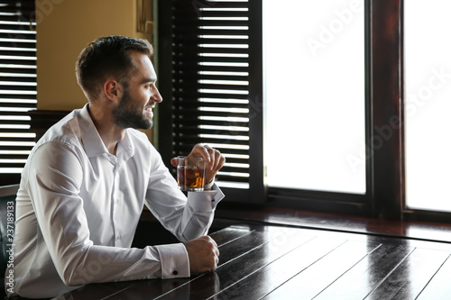 Young man drinking whiskey ...