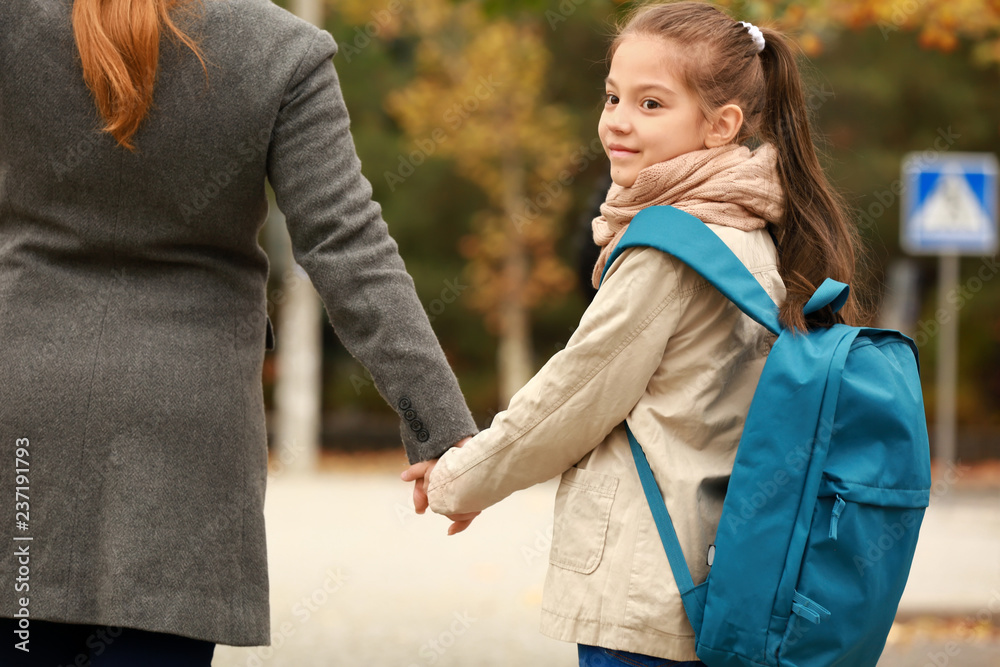 Cute girl going to school with her mother outdoors Stock Photo | Adobe ...