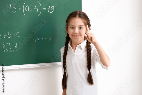 Cute girl standing near cha...