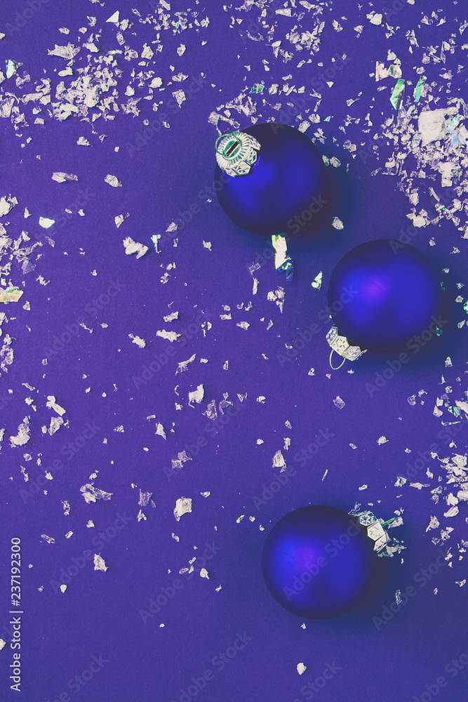 Christmas blue balls on a dark blue background with fake snow.