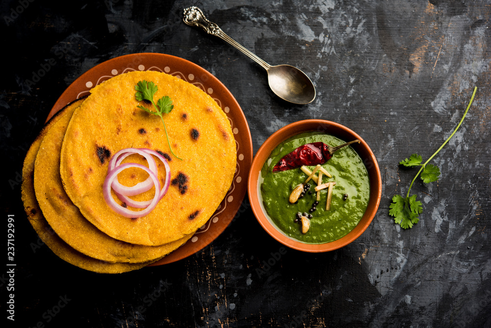 Makki di roti with sarson ka saag, popular punjabi main course recipe in winters made using corn breads mustard leaves curry. served over moody background. selective focus - obrazy, fototapety, plakaty 