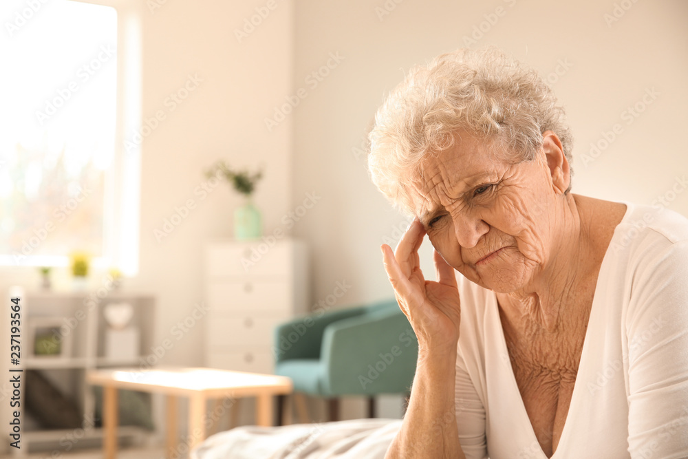 Senior woman suffering from headache at home Senior woman suffering from headache at home