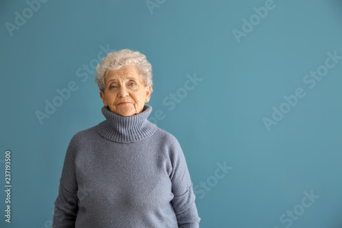 Portrait of senior woman on color background