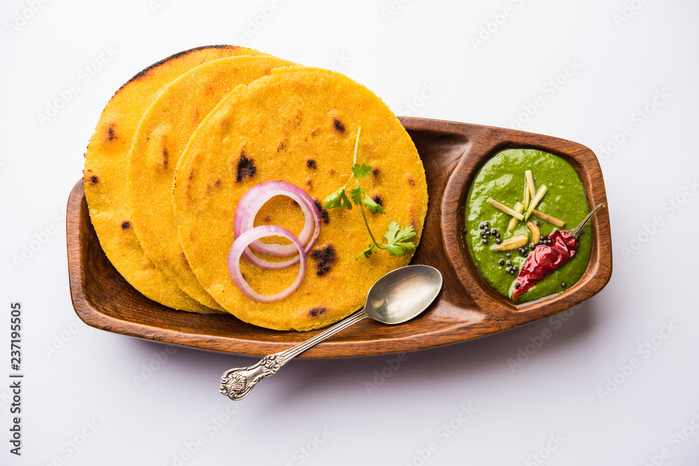 Makki di roti with sarson ka saag, popular punjabi main course recipe in winters made using corn breads mustard leaves curry. served over moody background. selective focus - obrazy, fototapety, plakaty 
