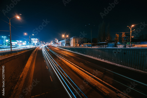 Transportation highway system with long exposure in dusk, shoted in Kyiv, Ukraine. Car trails on busy road. © Aleksander