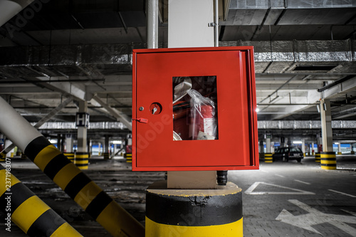 Red fire crane at underground parking with illuminated background