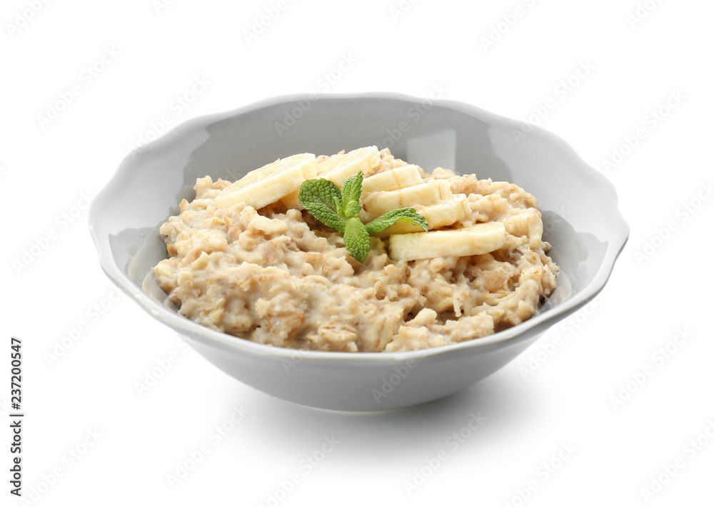 Plate with tasty oatmeal and banana slices on white background Plate with tasty oatmeal and banana slices on white background