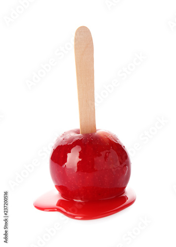 Stick with delicious caramel apple on white background