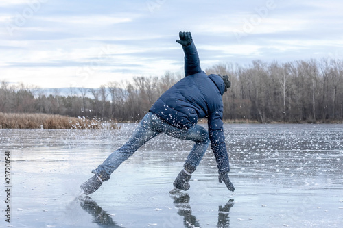 Man falling down while ice skating. Snow skates from the scatter in the parties.
