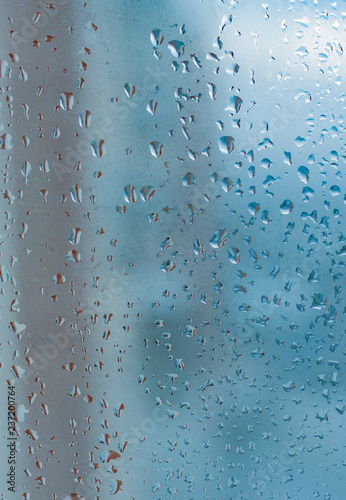 Water drops from home condensation on a window. Misted glass background. Strong humidity in wintertime