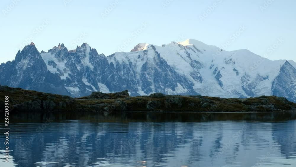 Colourful sunrise on Chesery lake (Lac De Cheserys) in France Alps. Monte Bianco mountain range on background. Vallon de Berard Nature Preserve, Chamonix, Graian Alps Colourful sunrise on Chesery lake (Lac De Cheserys) in France Alps. Monte Bianco mountain range on background. Vallon de Berard Nature Preserve, Chamonix, Graian Alps